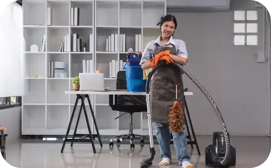Friendly professional cleaner with vacuum and duster ready for office bond cleaning at Busy B Cleaning